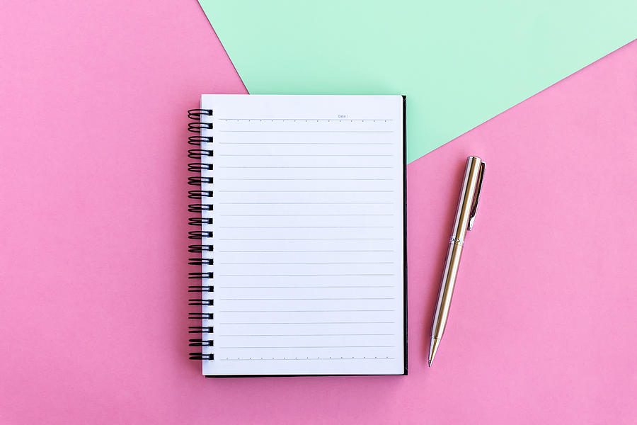 Note Pad and Pen on Pink and Green Background Photograph by Nora Carol Photography