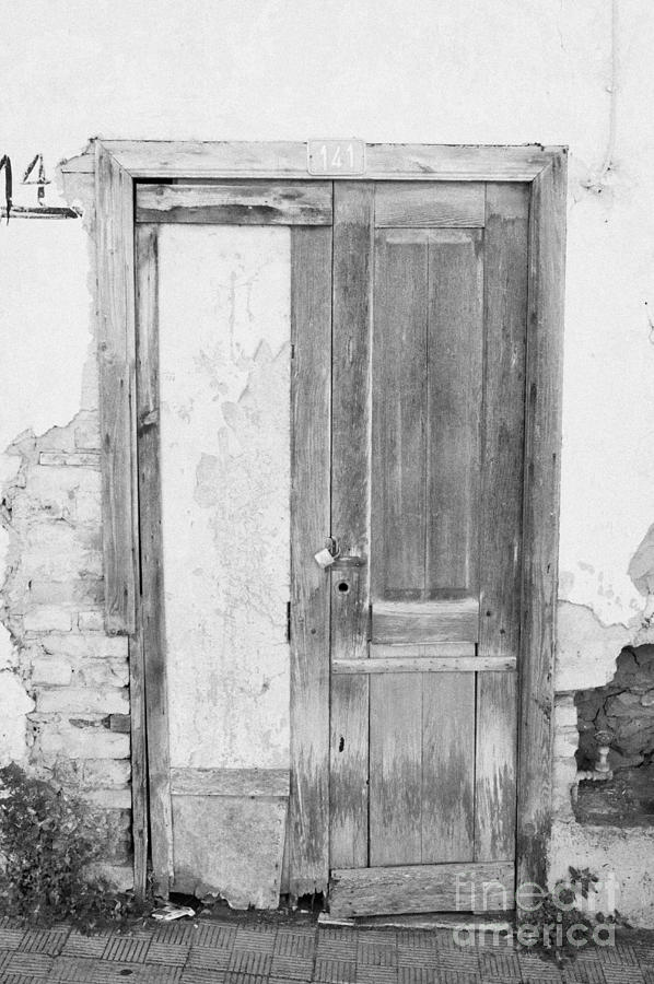 number 141 old weathered brown wooden door entrance to abandoned house ...