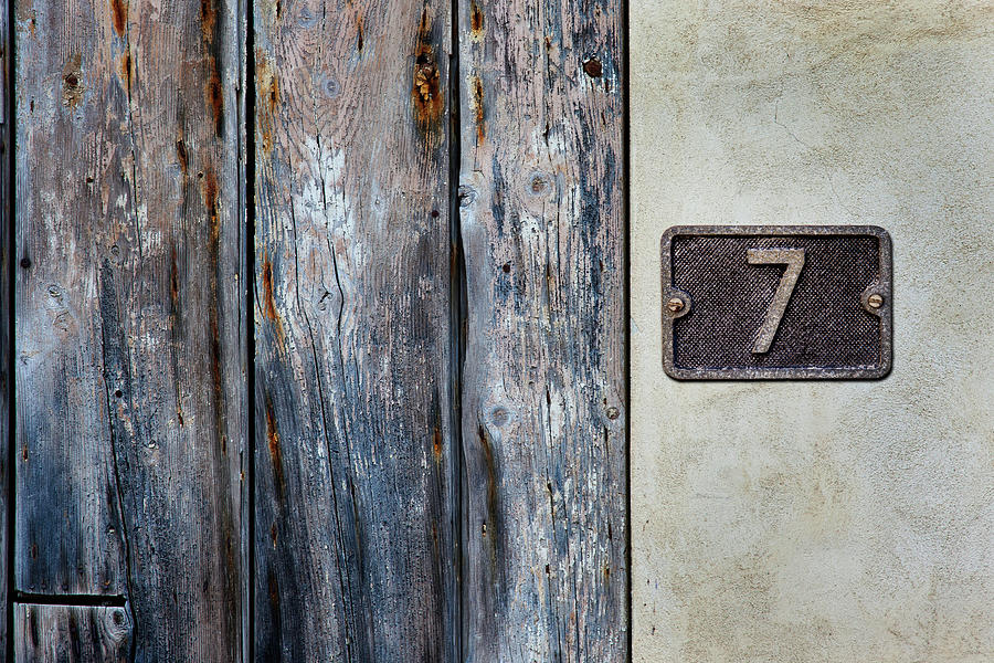 Number 7 Metal Sign Close To An Old Photograph by Andrew Bret Wallis