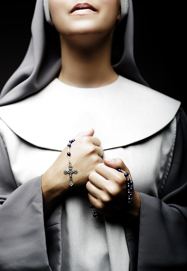 Nun in prayer Photograph by Bubbalove
