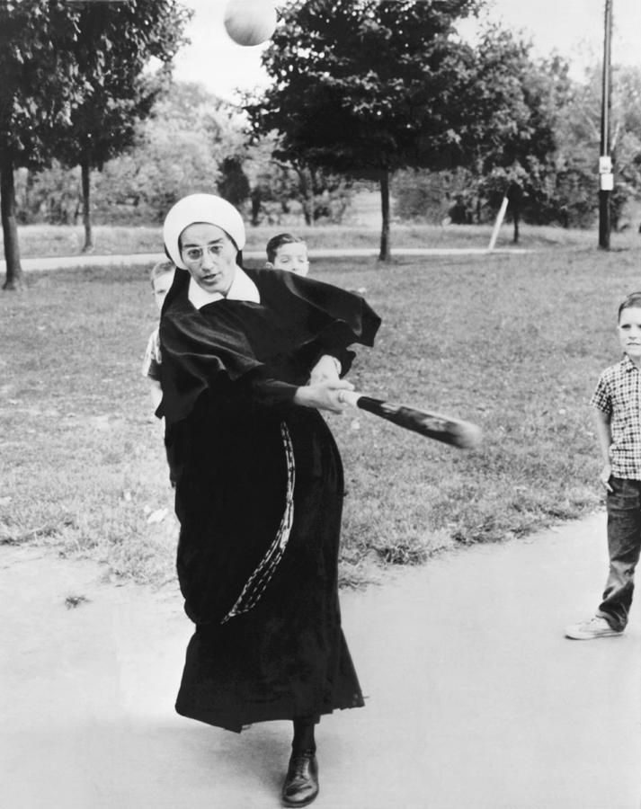 Nun Swinging A Baseball Bat Photograph by Underwood Archives