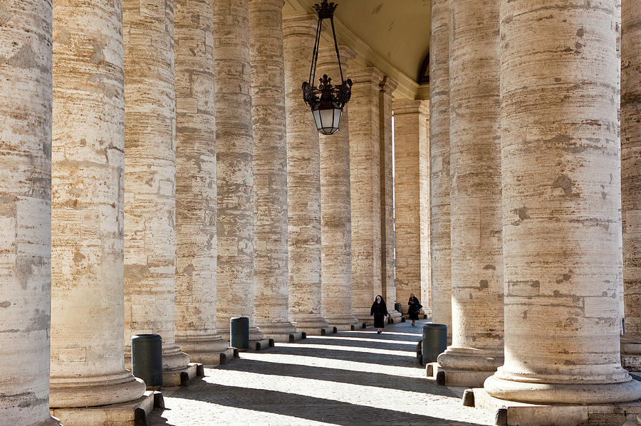 Architecture Photograph - Nun Walking Through Colonnade On Piazza by Richard Ianson