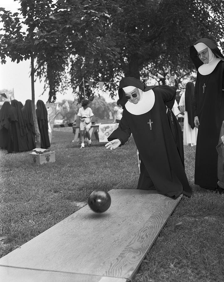 Black And White Photograph - Nuns Bowling by Underwood Archives