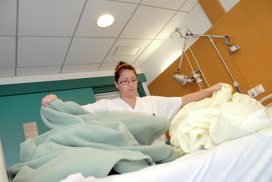 Nurse Changing Hospital Bed Linen Photograph by Aj Photo/science Photo Library