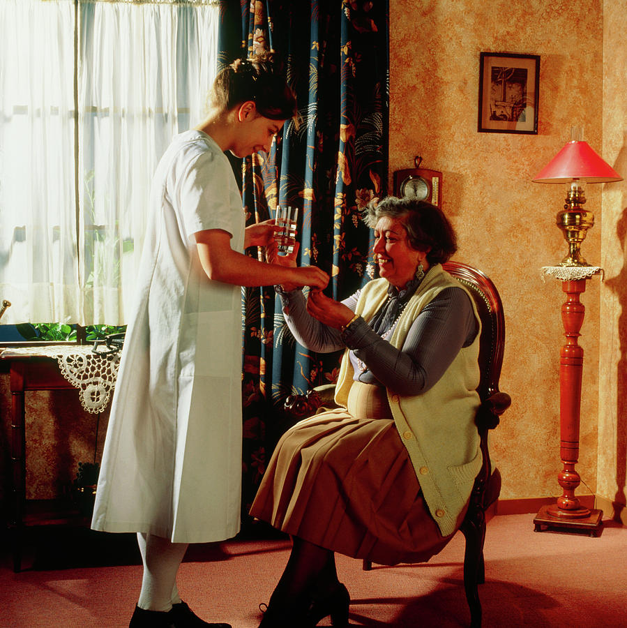 Nurse Gives Elderly Woman Her Medication At Home Photograph by Cc Studio/science Photo Library