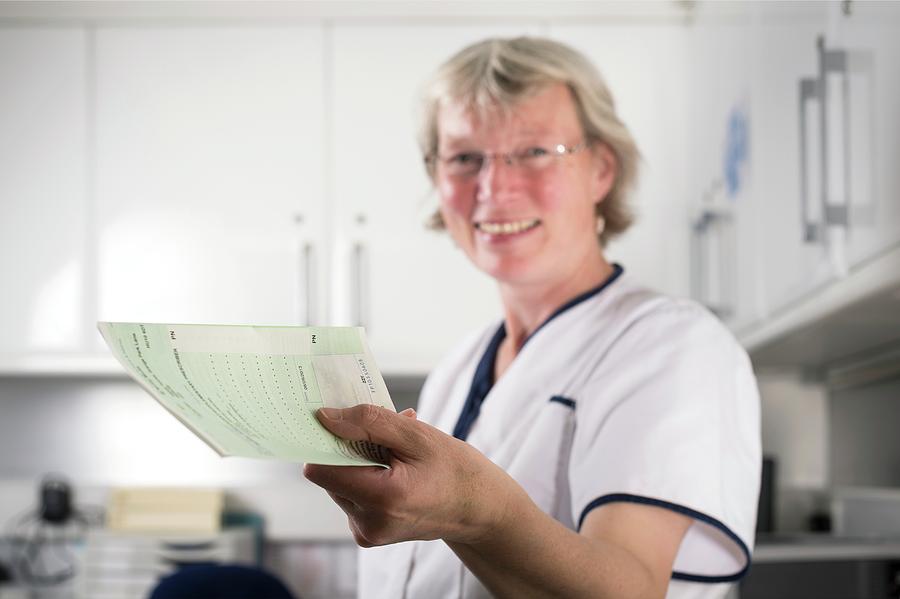 Nurse Handing Out Prescription Photograph by Jim Varney