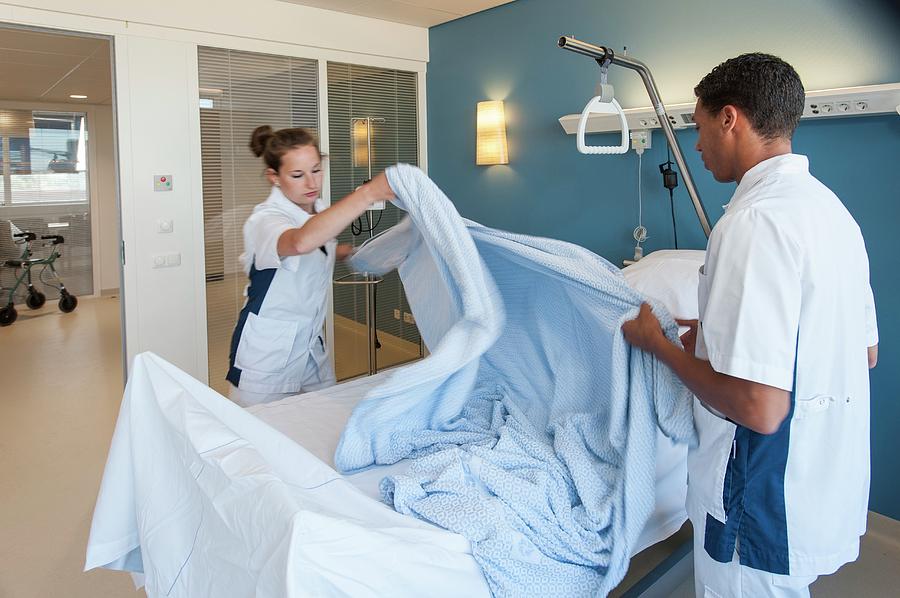 Nurse Making Hospital Bed Photograph by Arno Massee/science Photo ...