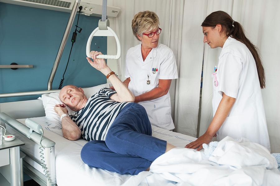 Nurses Assisting Patient Photograph by Arno Massee/science Photo Library