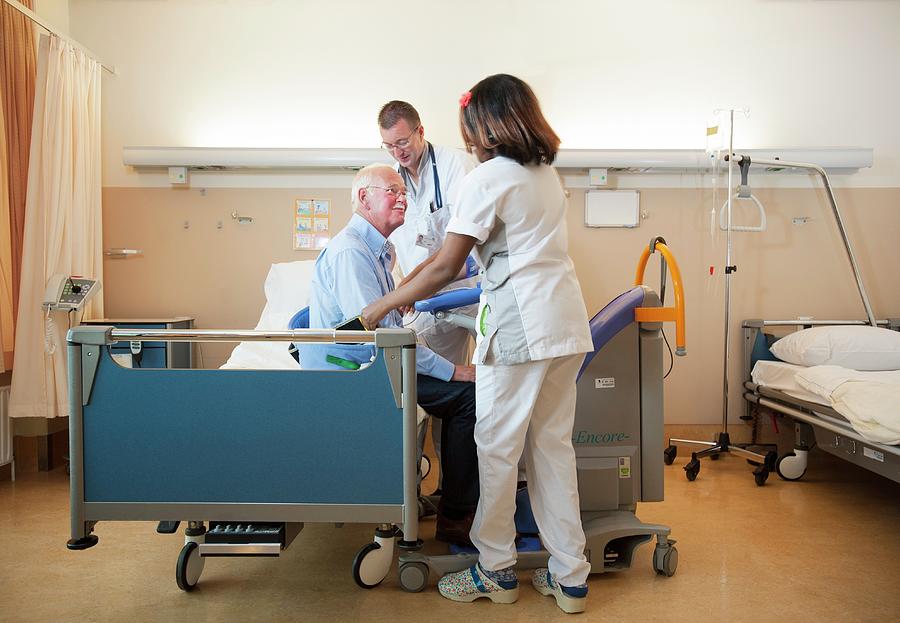 Nurses Helping A Patient Out Of Bed Photograph By Arno Massee Science Photo Library Fine Art