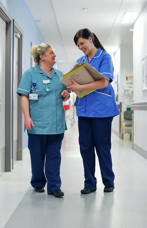 Nurses Talking In Corridor Photograph by Lth Nhs Trust/science Photo Library