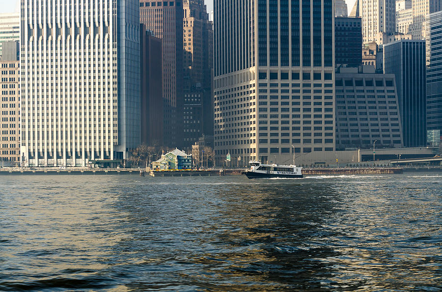 NY Waterway Ferry Passing The Downtown Manhattan Heliport at Pier 6 Photograph by Maureen E Ritter