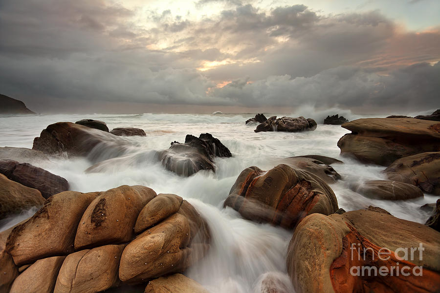 Ocean Surges Over Weathered Rocks Photograph