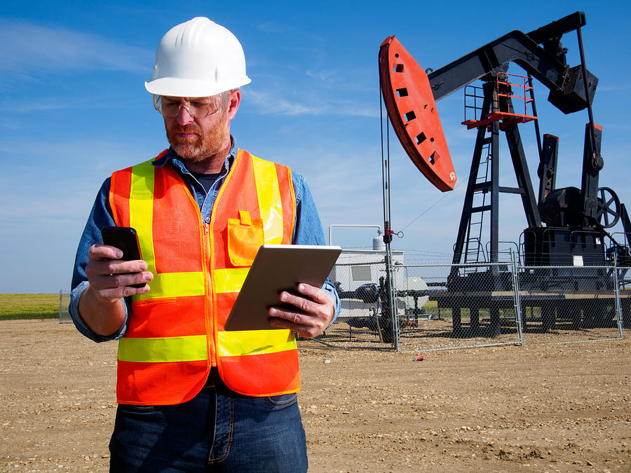 Oil Engineer with Tablet Computer and Pumpjack Photograph by Shotbydave