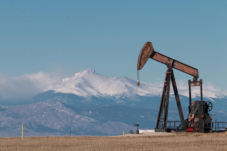 Oil Pumpjack in the Shadows of the Rockies Photograph by Tony Hake