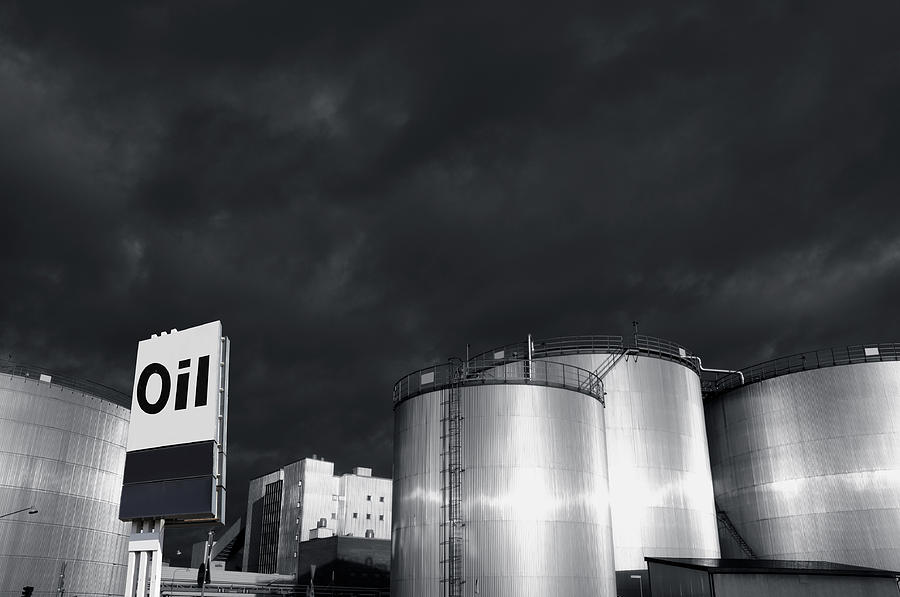 Oil Refinery At Sunset With Commercial Sign Photograph by Christian Lagereek