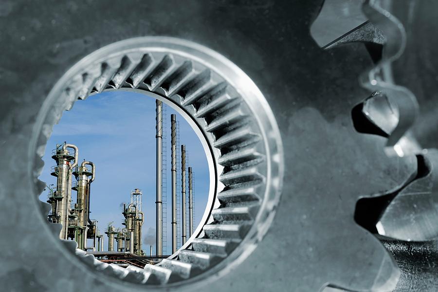 Oil Refinery Seen Through Industrial Gears Photograph by Christian Lagerek/science Photo Library
