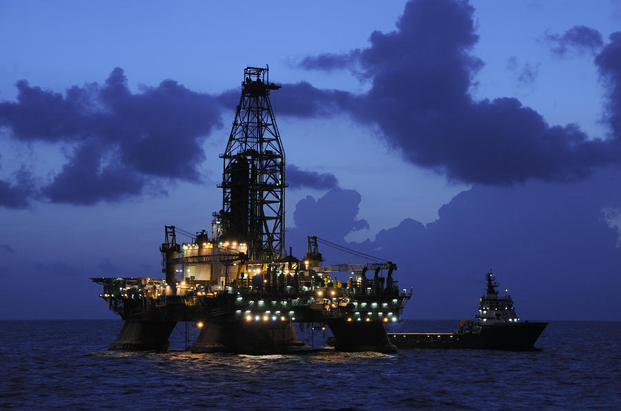 Oil Rig and Vessel at Night Photograph by Bradford Martin