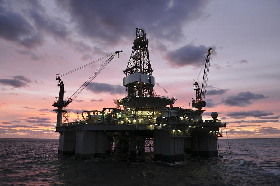 Oil rig at dawn Photograph by Bradford Martin