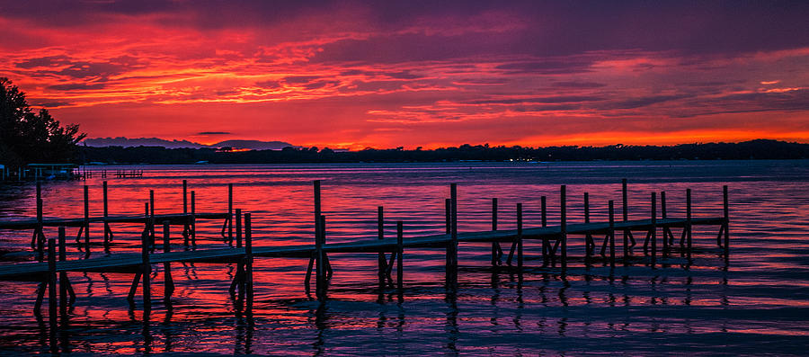 Okoboji dock sunset Photograph by Lowell Monke