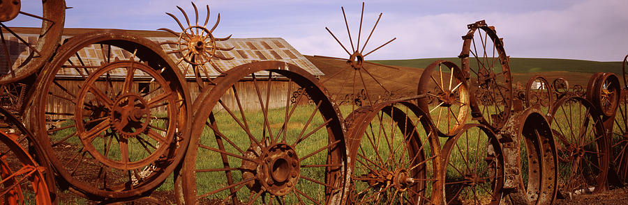 Old Barn With A Fence Made Of Wheels Photograph by Panoramic Images