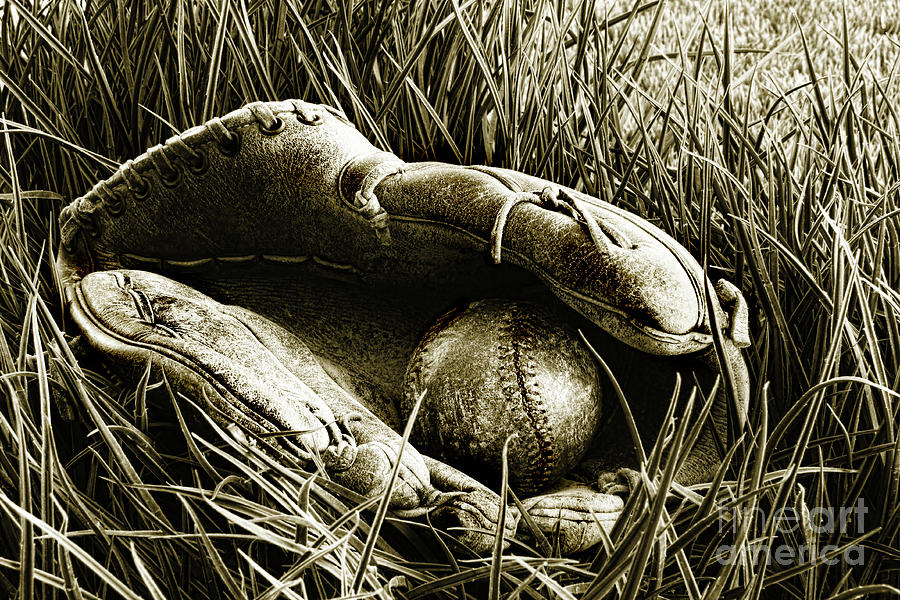 Old baseball glove with ball in the grass Photograph by Sandra Cunningham