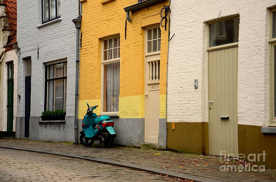 Old cobbled street and green scooter Photograph by Imran Ahmed