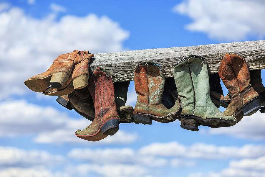 Old Cowboy Boots Hanging In Memory Photograph by Ken Gillespie