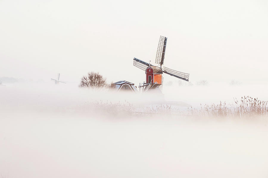 Old Fashioned Windmill In Misty Photograph by Arno Masse