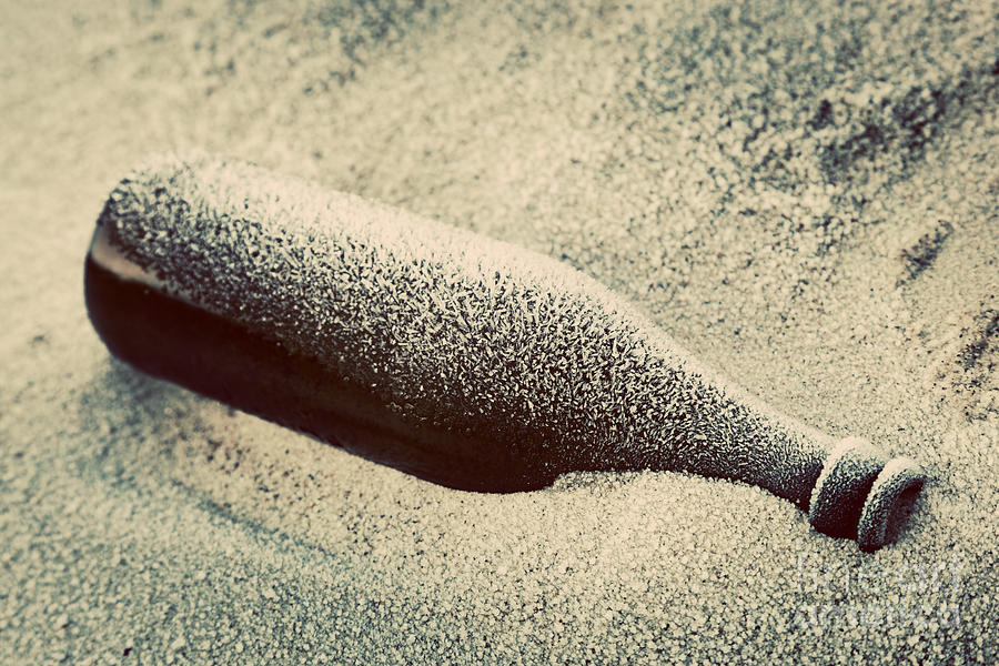 Old frozen bottle lost on the beach Photograph by Michal Bednarek