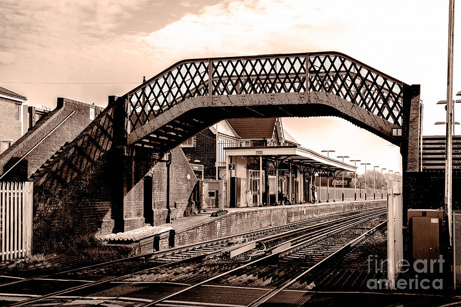 Old iron pedestrian bridge across railway by station. Photograph by Peter Noyce