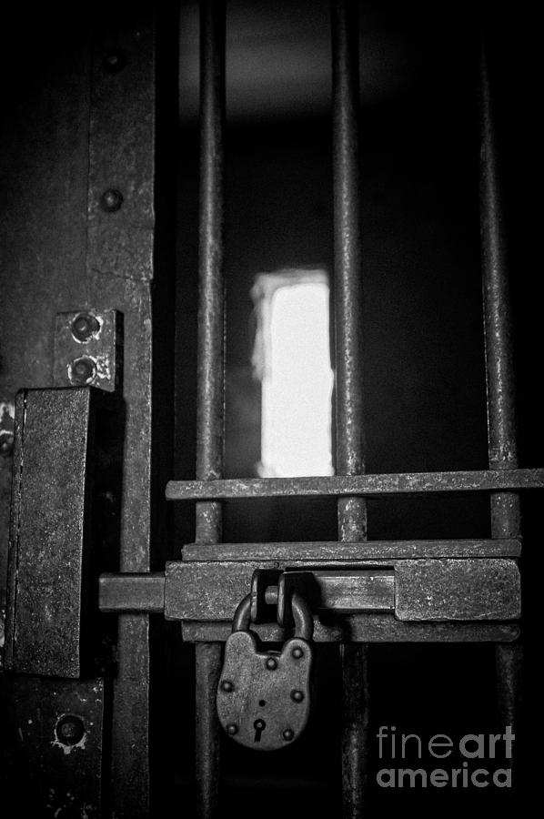 Old jail cell door with antique lock Photograph by Imagery by Charly