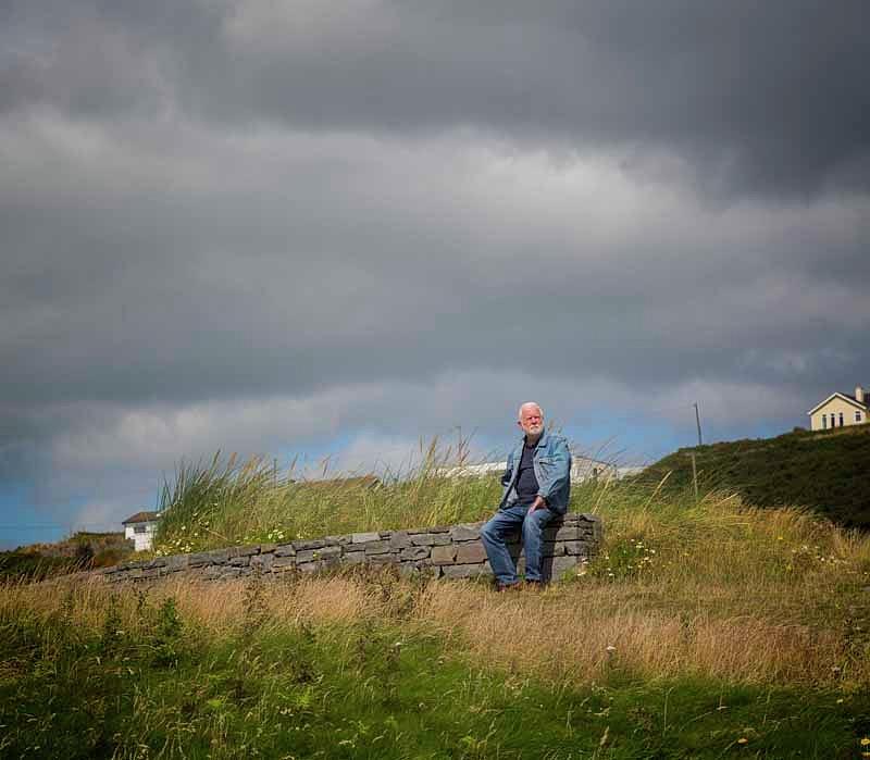 Old Man Sitting On Stone Wall Photograph by Ken Welsh - Pixels