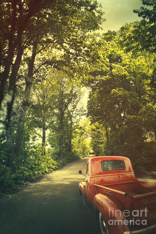 Old red pickup truck driving on dirt road Photograph by Sandra Cunningham
