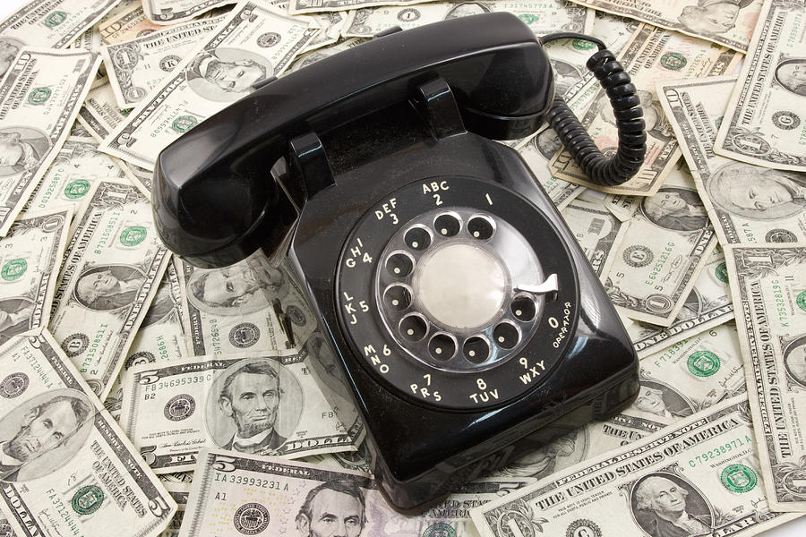 Vintage Photograph - Old Rotary Phone On Money Background by Keith Webber Jr