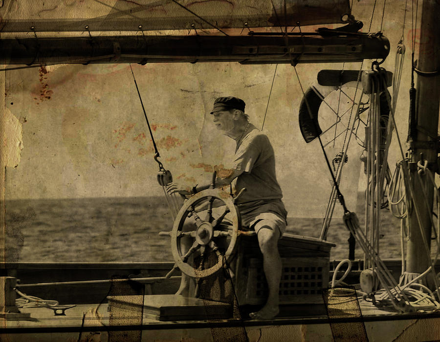 old sailor A vintage processed photo of a sailor sitted behind the rudder in Mediterranean sailing Photograph