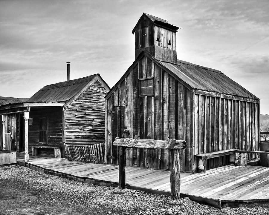 Black And White Photograph - Old West Hitching Post by James Eddy