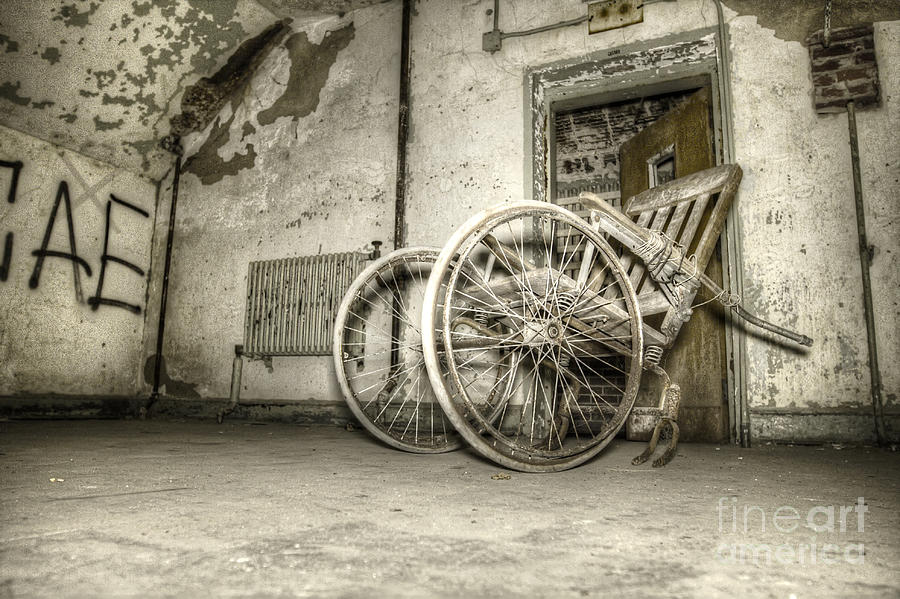 Old Wheelchair in Asylum Photograph by Morbid Images