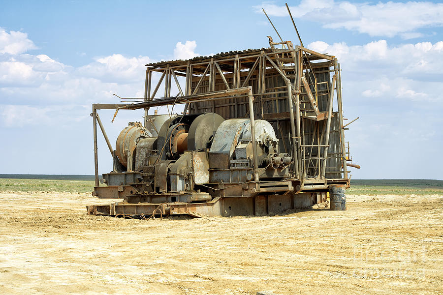 Landscape Photograph - Old winch with a drilling rig. by Alexandr  Malyshev