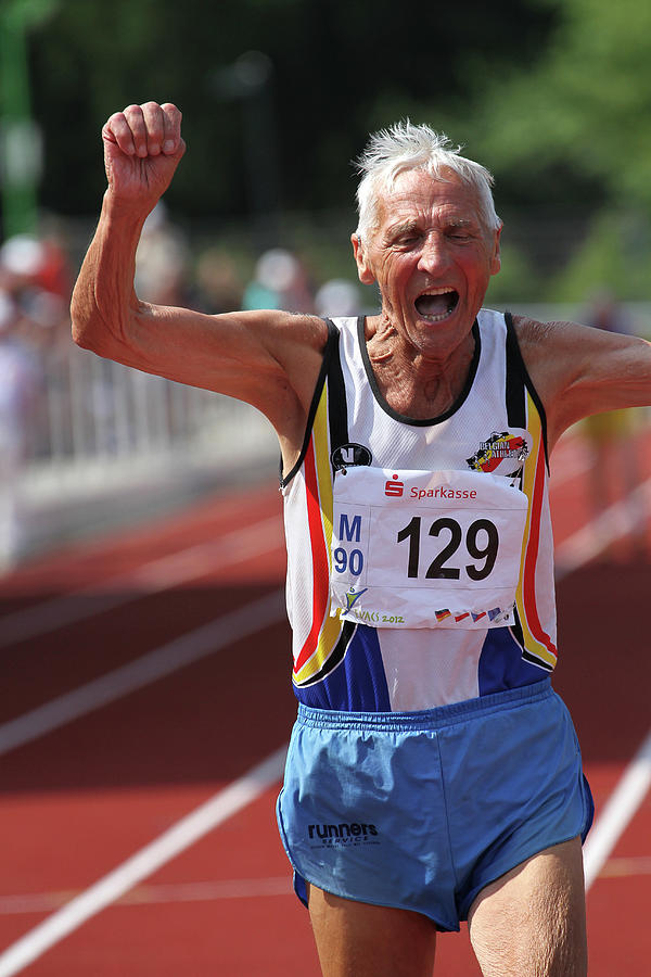 Athlete Photograph - Older Athlete Triumphs by Alex Rotas