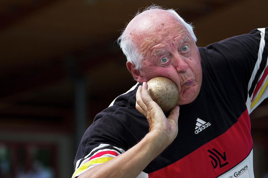 Older Man About To Throw Shot Put Photograph by Alex Rotas