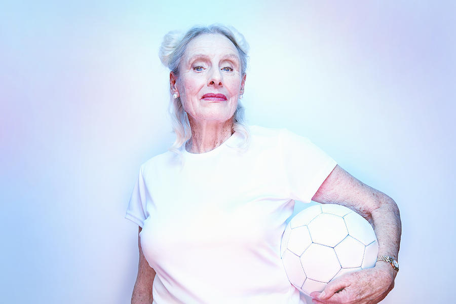 Older Woman Holding Football Photograph by Tara Moore
