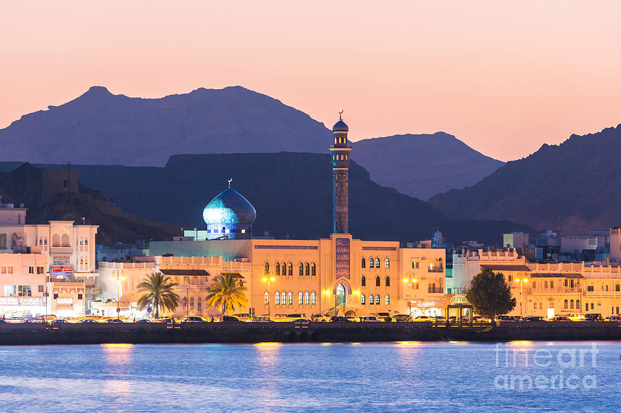 Oman - Muscat - Mutrah harbour and old town at dusk Photograph by Matteo Colombo