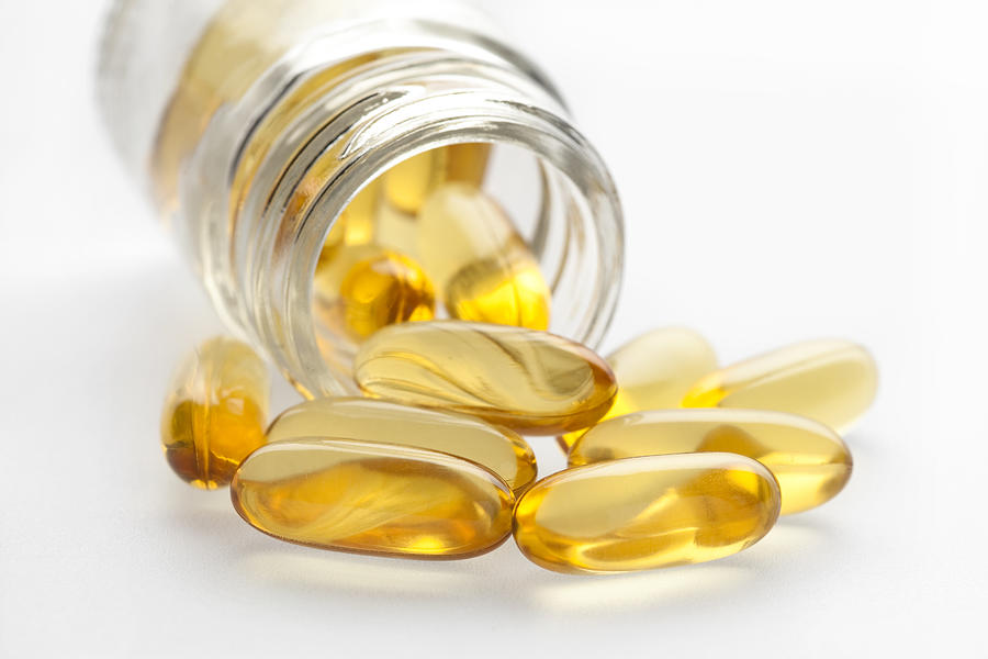 Omega 3 fish oil capsules and bottle Photograph by MarsBars