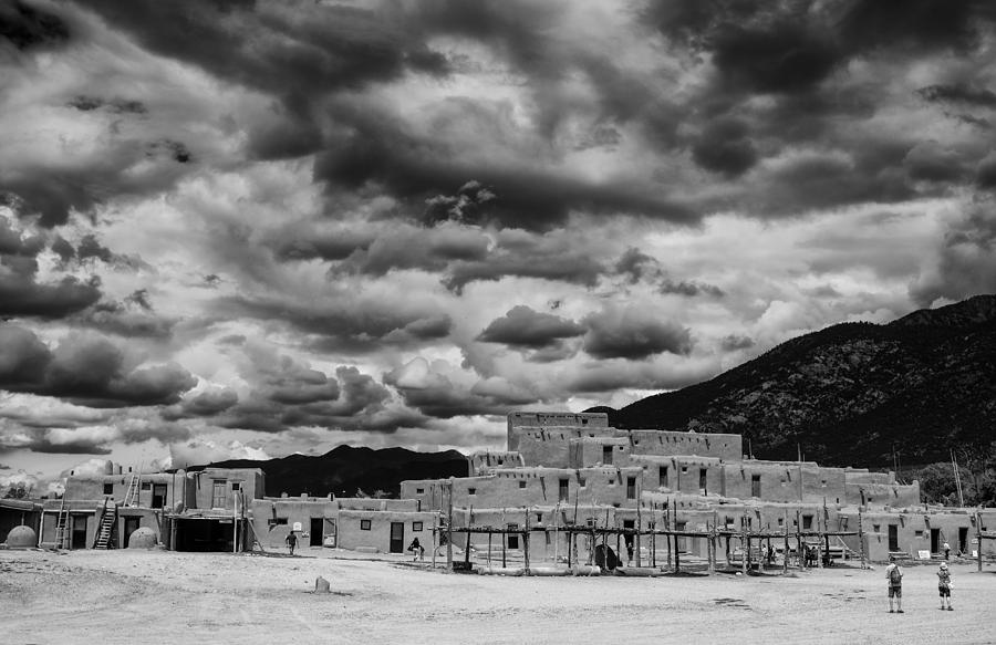 Taos Photograph - Ominous Clouds over Taos Pueblo by Silvio Ligutti