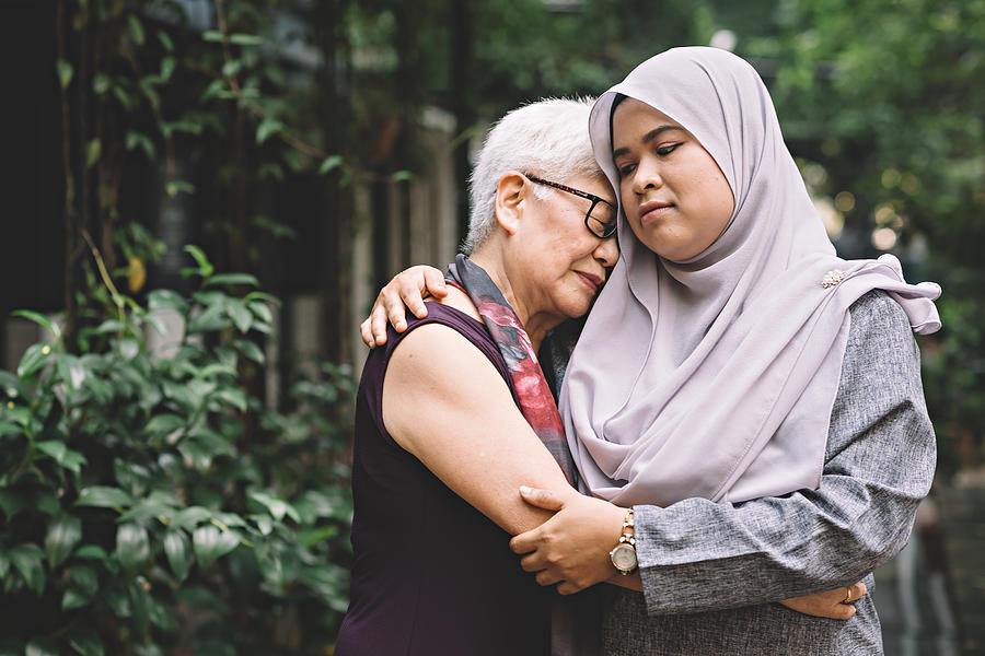 One Matured Asian Chinese Female Talking And Hugging A Middle Age Asian Malay Female With Sad Expression Photograph by Chee Gin Tan