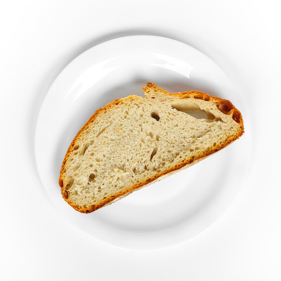 Bread Photograph - One slice of bread white plate and background by Matthias Hauser
