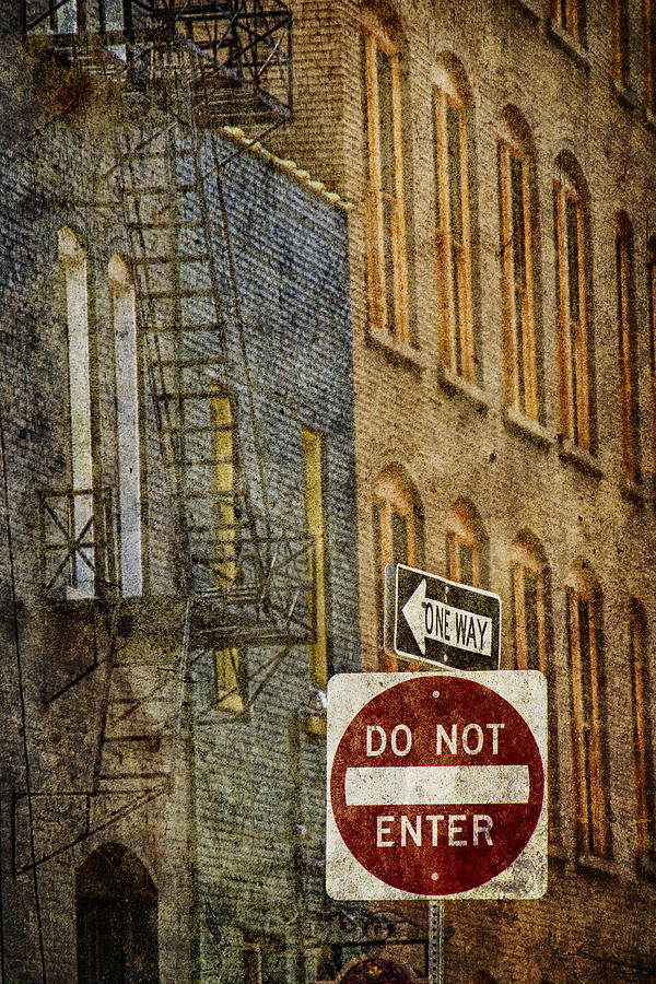 One Way and Do Not Enter Signs in Front of High Rise Building with Fire Escape Photograph by Randall Nyhof