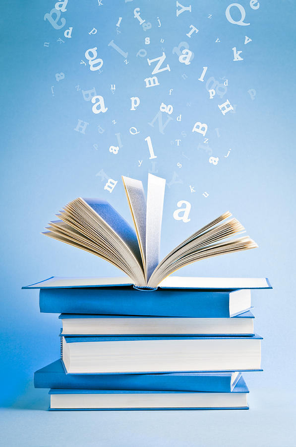 Open book with flying, scattered letters isolated on blue background Photograph by Domin_domin