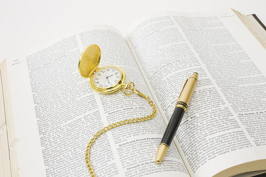 Open book with fountain pen and pocket watch Photograph by GYRO PHOTOGRAPHY/amanaimagesRF
