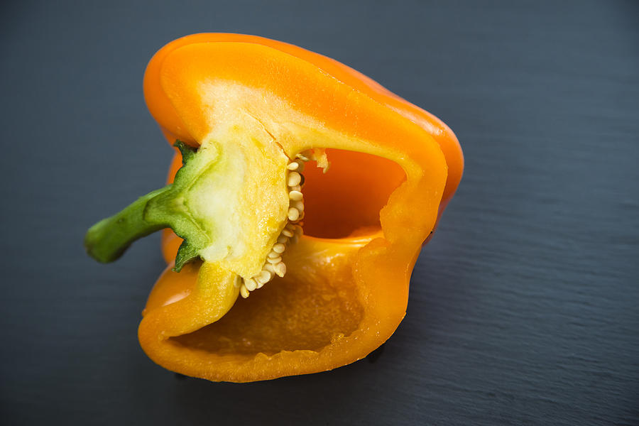 Orange bell pepper cut in half Photograph by Matthias Hauser